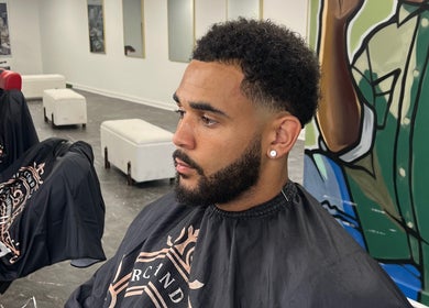Client at MG TRIMZ experiencing a stylish haircut in Leeds, England, GB, showcasing barber expertise.