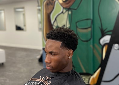 Modern haircut at MG TRIMZ, Leeds, England, GB with detailed wall art in the background.