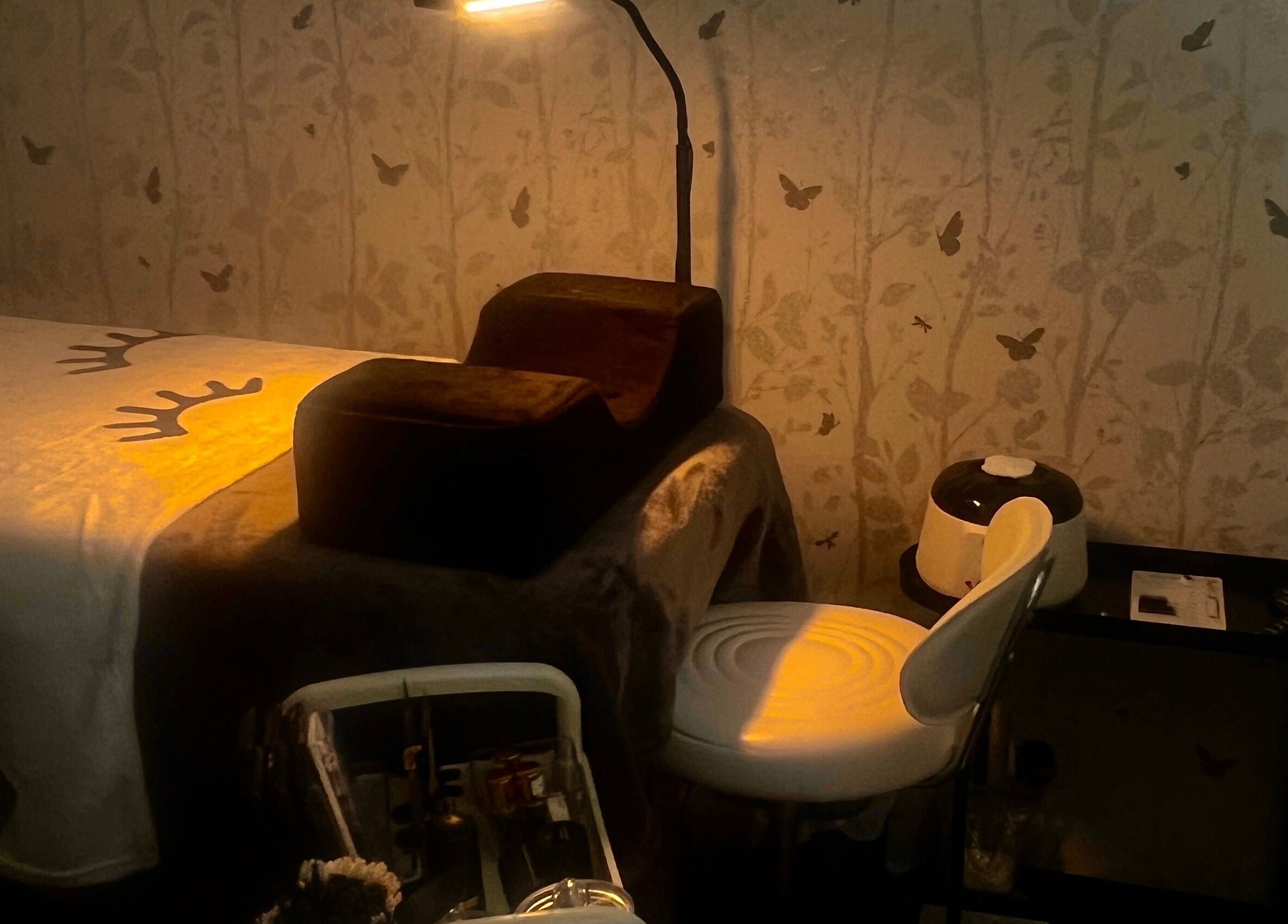 Tranquil treatment room at Lush Lab, Burnley, England, GB with a softly lit bed and calming wall art.