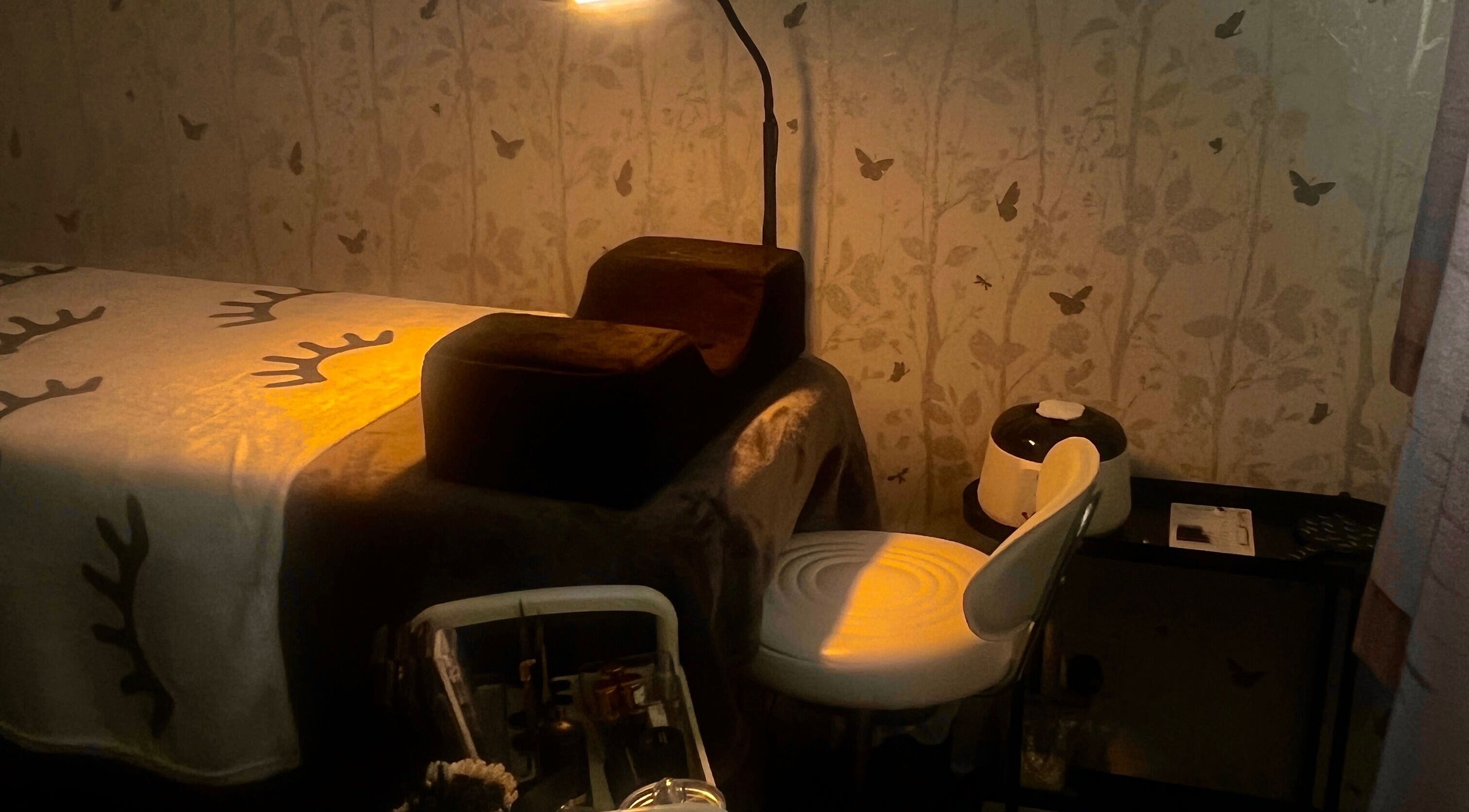 Tranquil treatment room at Lush Lab, Burnley, England, GB with a softly lit bed and calming wall art.