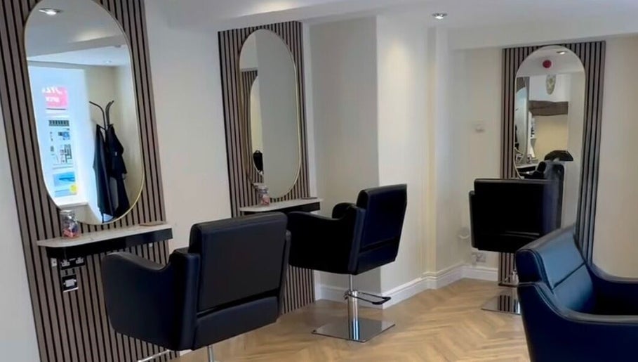 Stylish hairdressing area at Jasmin Eden Hair, Newport, Shropshire, GB featuring modern chairs and mirrors.