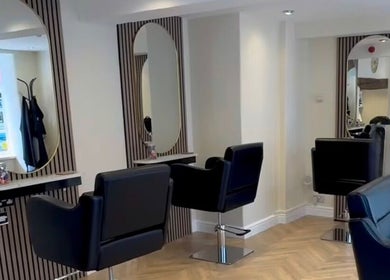 Stylish hairdressing area at Jasmin Eden Hair, Newport, Shropshire, GB featuring modern chairs and mirrors.