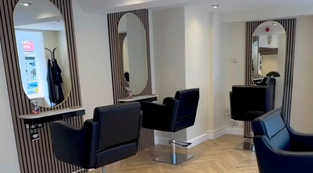 Stylish hairdressing area at Jasmin Eden Hair, Newport, Shropshire, GB featuring modern chairs and mirrors.