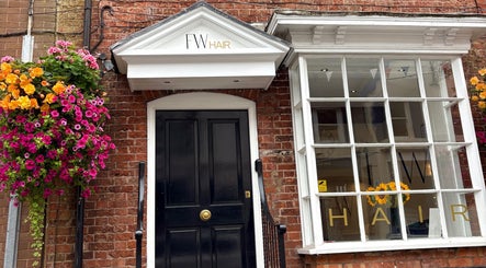 Exterior of Jasmin Eden Hair with flowers in Newport, Shropshire, GB.