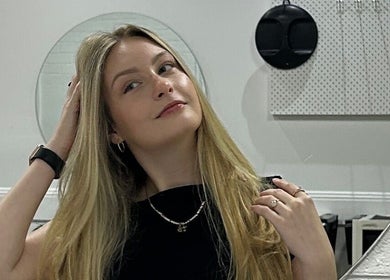 Customer admires new hairstyle in mirror at The Hair Society By Leearne, Budgewoi, New South Wales, AU.