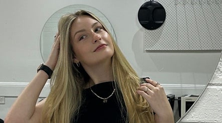 Customer admires new hairstyle in mirror at The Hair Society By Leearne, Budgewoi, New South Wales, AU.