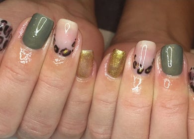Chic manicure at Jade Billings Hair & Beauty in Chelmsford, England, GB with gold and animal print designs.