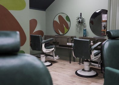 Modern barber chairs in Lishmans Barbershop, Newcastle upon Tyne, England, GB with stylish decor.