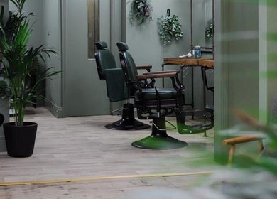 Elegant barber chairs at Lishmans Barbershop in Newcastle upon Tyne, England, GB with stylish decor.