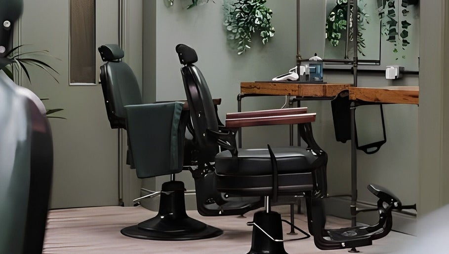 Interior of Lishmans Barbershop in Newcastle upon Tyne, England, GB featuring stylish chairs and elegant decor.