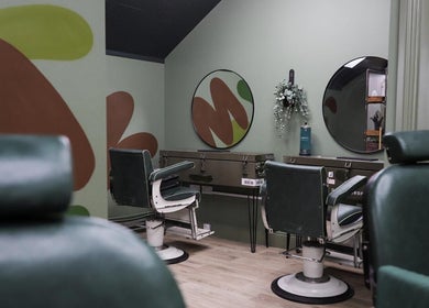 Chic barber chairs at Lishmans Barbershop, Newcastle upon Tyne, England, GB showcasing modern design.