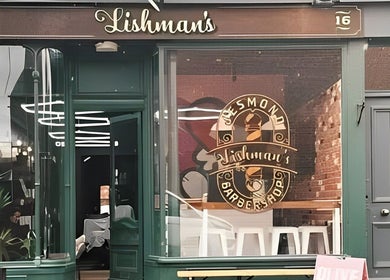 Exterior of Lishmans Barbershop, Newcastle upon Tyne, England, GB featuring stylish signage.