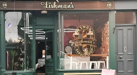 Exterior of Lishmans Barbershop, Newcastle upon Tyne, England, GB featuring stylish signage.