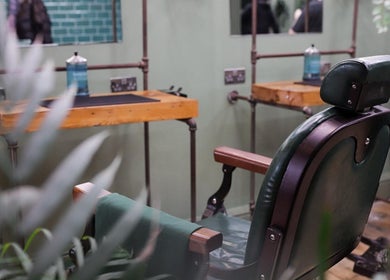 Vintage barber chair at Lishmans Barbershop, Newcastle upon Tyne, England, GB showcasing rustic elegance.