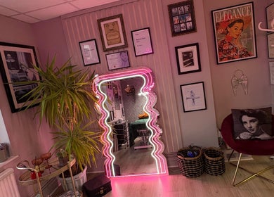 Stylish corner at Very Bettie, Horley, England, GB with neon mirror and elegant decor.
