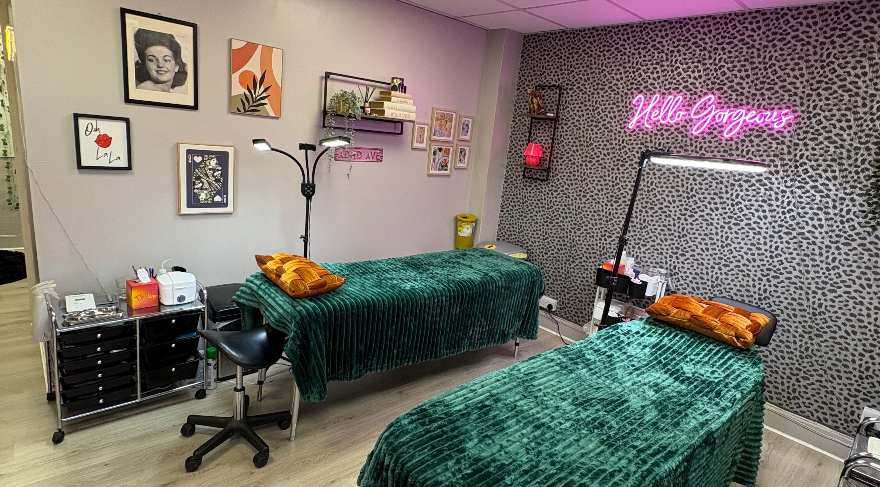 Stylish treatment room at Very Bettie, Horley, England, GB with green beds and vibrant decor.