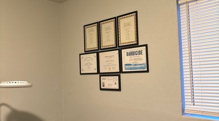 Certificates and licenses on wall at Bratzified Beauty, Douglas, Arizona, US showcase expertise.