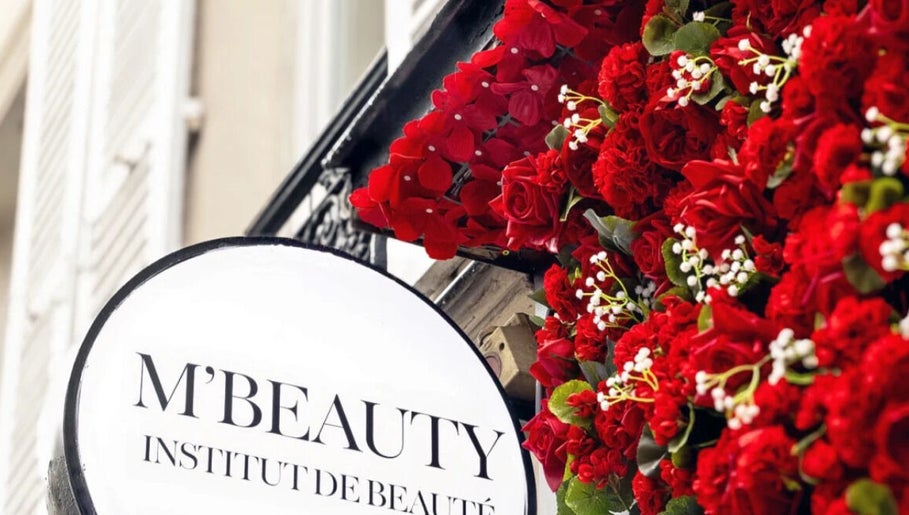 Façade fleurie de M'Beauty à Paris, Île-de-France, FR avec roses rouges vibrantes.