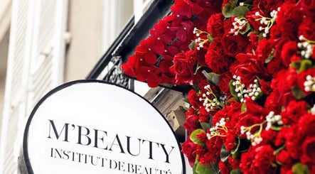Façade fleurie de M'Beauty à Paris, Île-de-France, FR avec roses rouges vibrantes.