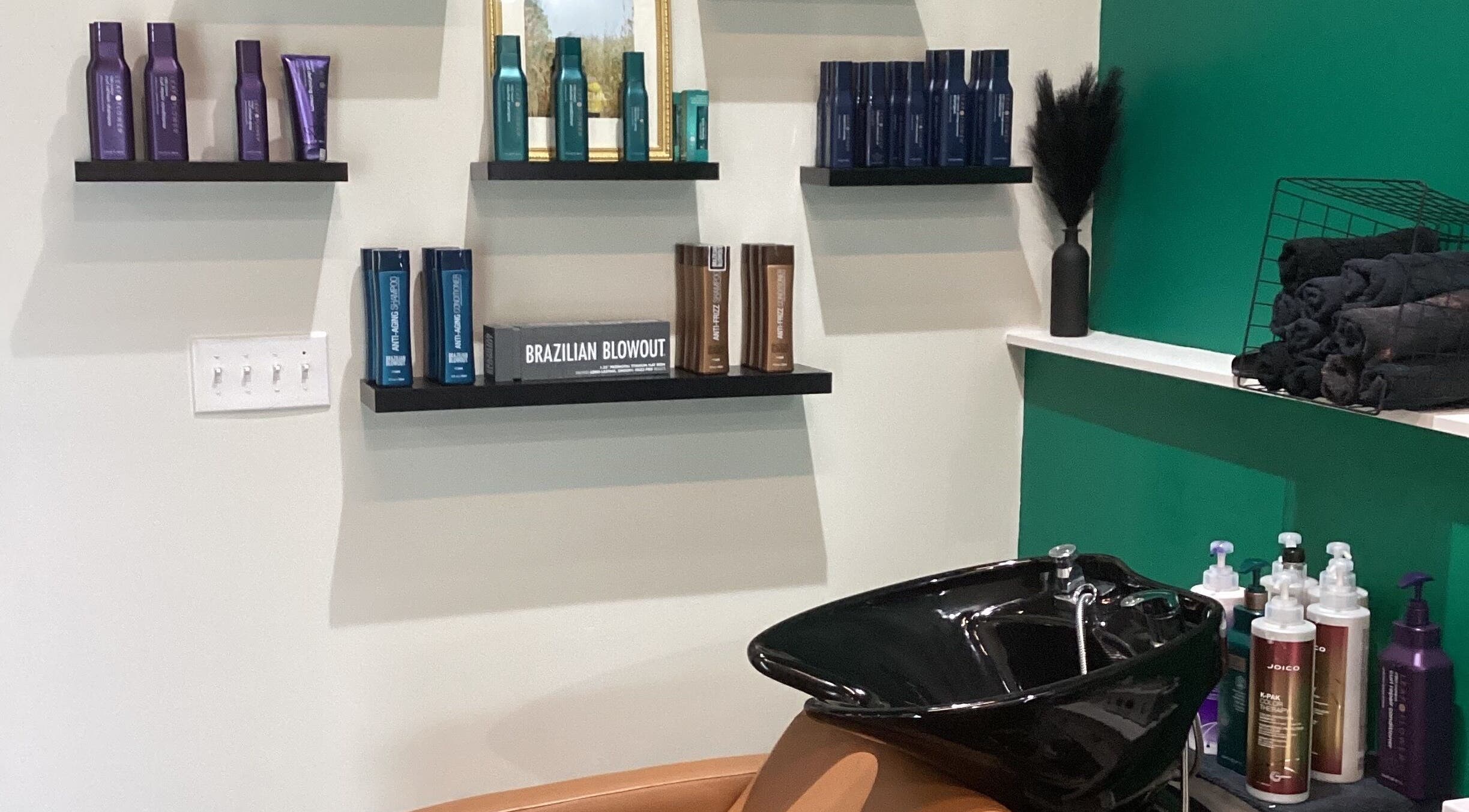 Wash station and branded products at Styles By Kelly in Ruston, Louisiana, US.