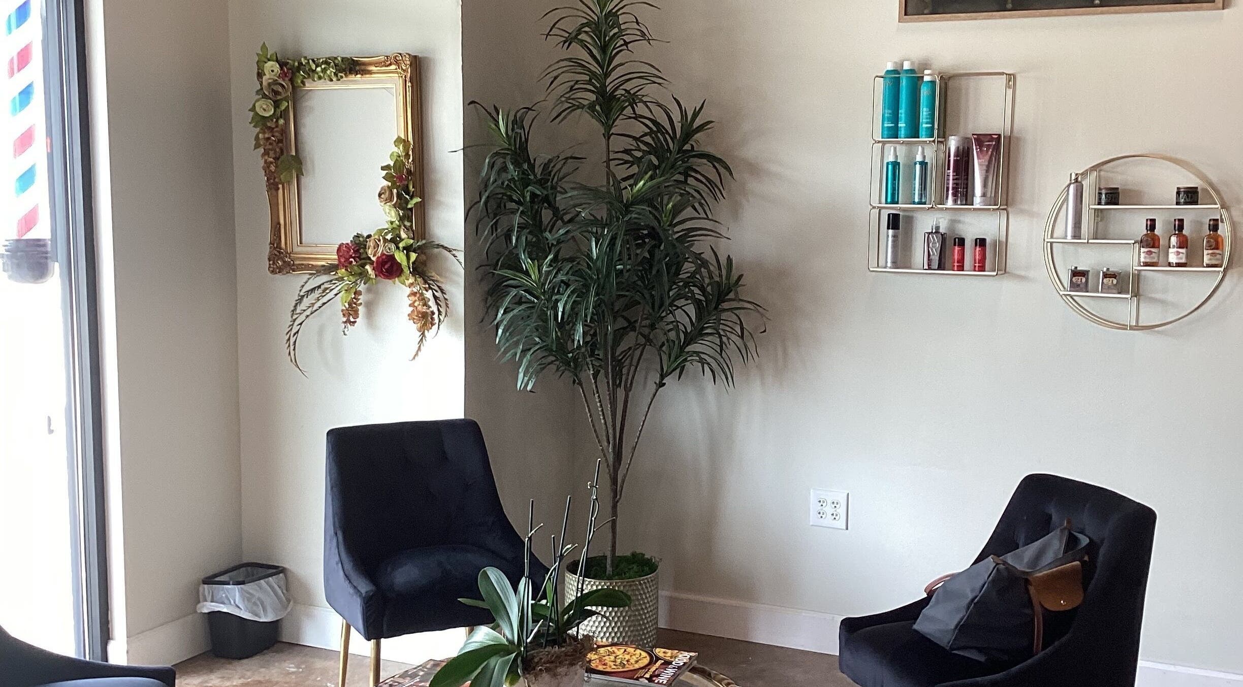 Cozy corner at Styles By Kelly, Ruston, Louisiana, with plants and shelves displaying beauty products.