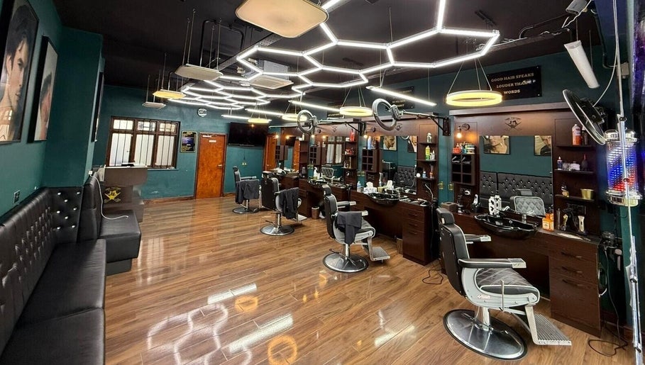 Stylish interior of Fade Factory, a modern beauty salon in Morden, England, GB with sleek design and barber chairs.