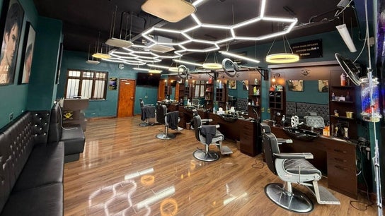 Stylish interior of Fade Factory, a modern beauty salon in Morden, England, GB with sleek design and barber chairs.