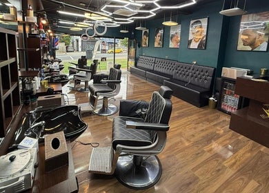 Modern interior of Fade Factory barbershop in Morden, England, GB with stylish chairs and decor.