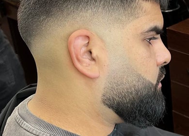 Crisp fade haircut at Fade Factory in Morden, England, GB, showcasing professional grooming techniques.