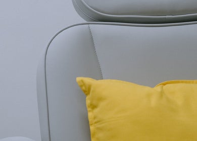 Comfy white chair with a bright yellow cushion at Mercredi. Mani and Pedi, Central, Hong Kong Island, HK.