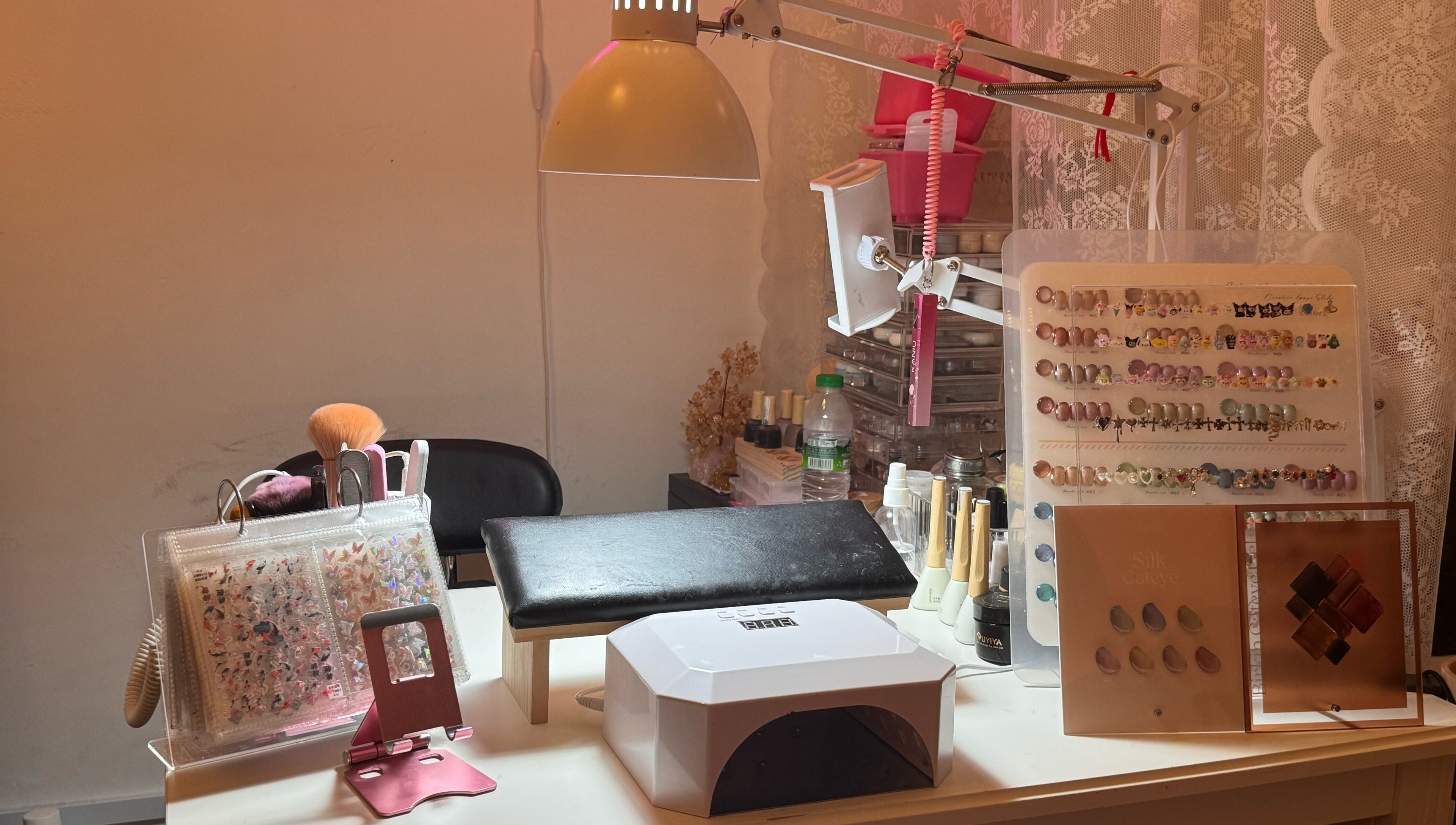 Nail art setup at The Belle Studio, Singapore, Singapore, SG. Includes UV lamp, brushes, and nail colors.