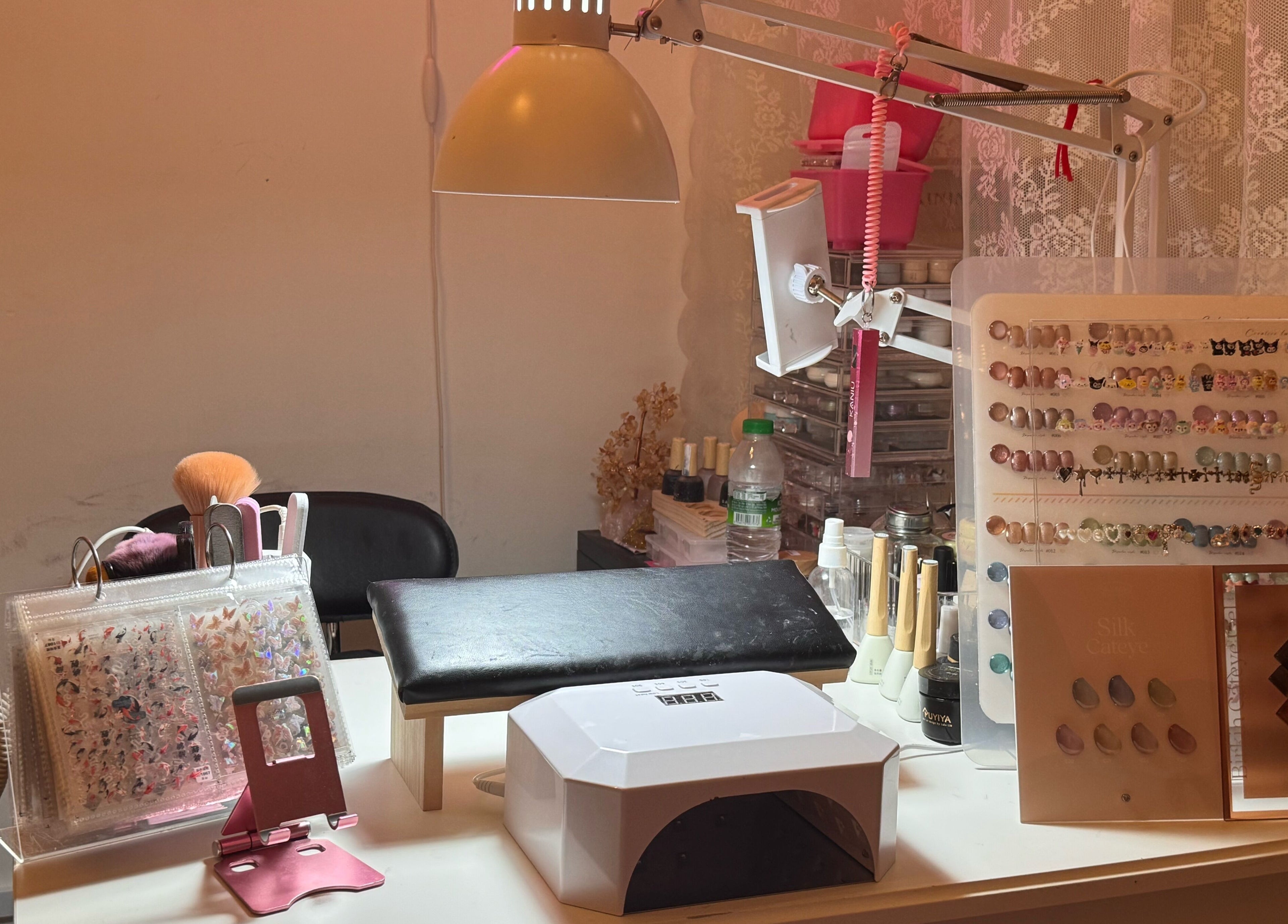Nail art setup at The Belle Studio, Singapore, Singapore, SG. Includes UV lamp, brushes, and nail colors.