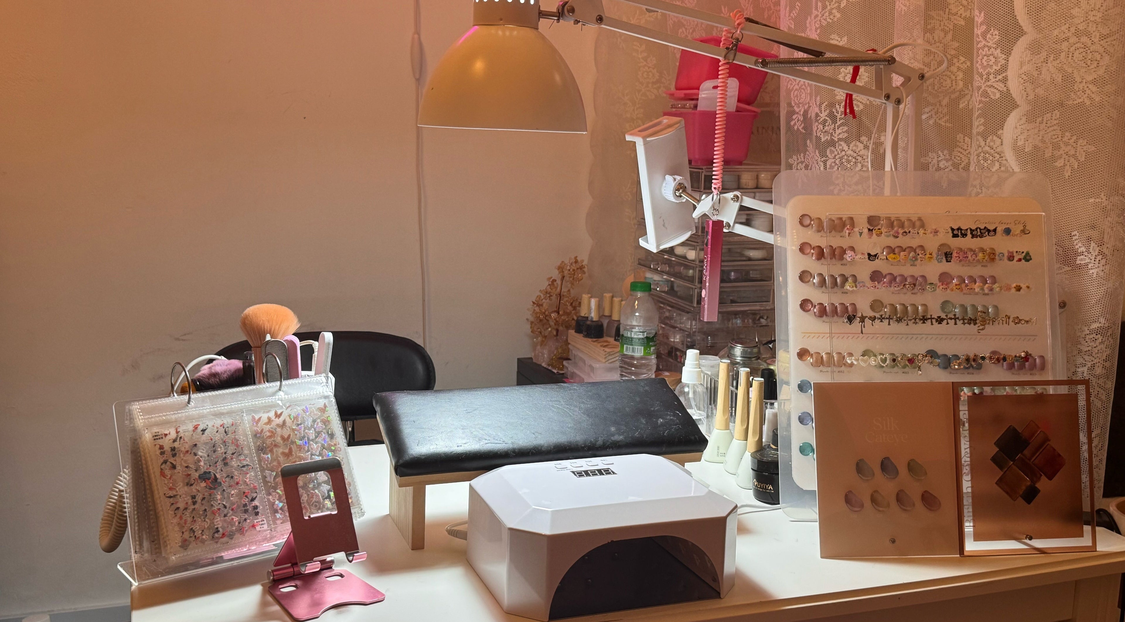 Nail art setup at The Belle Studio, Singapore, Singapore, SG. Includes UV lamp, brushes, and nail colors.