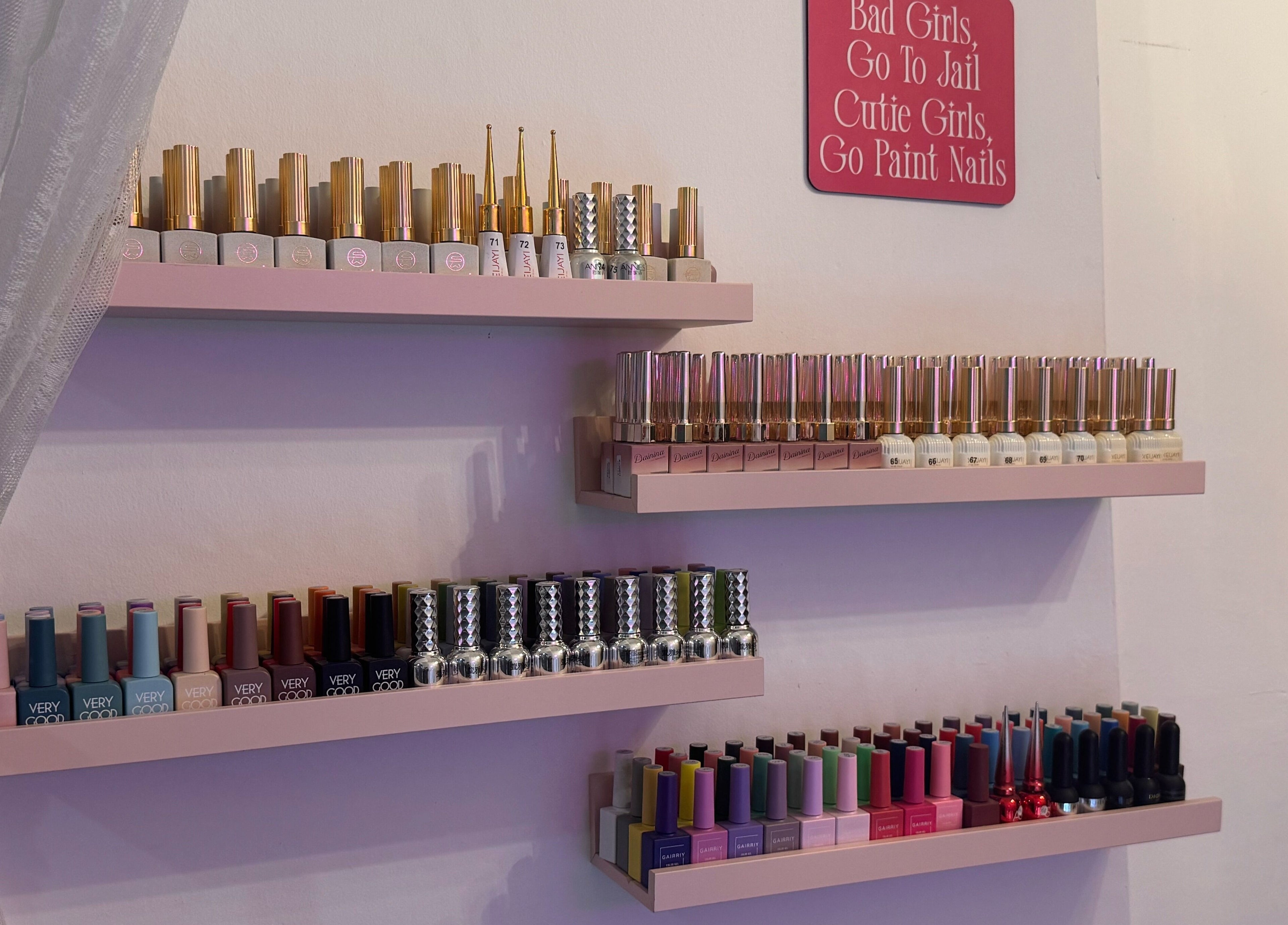 Nail polish collection at The Belle Studio, Singapore, SG showcasing vibrant colors on elegant shelves.