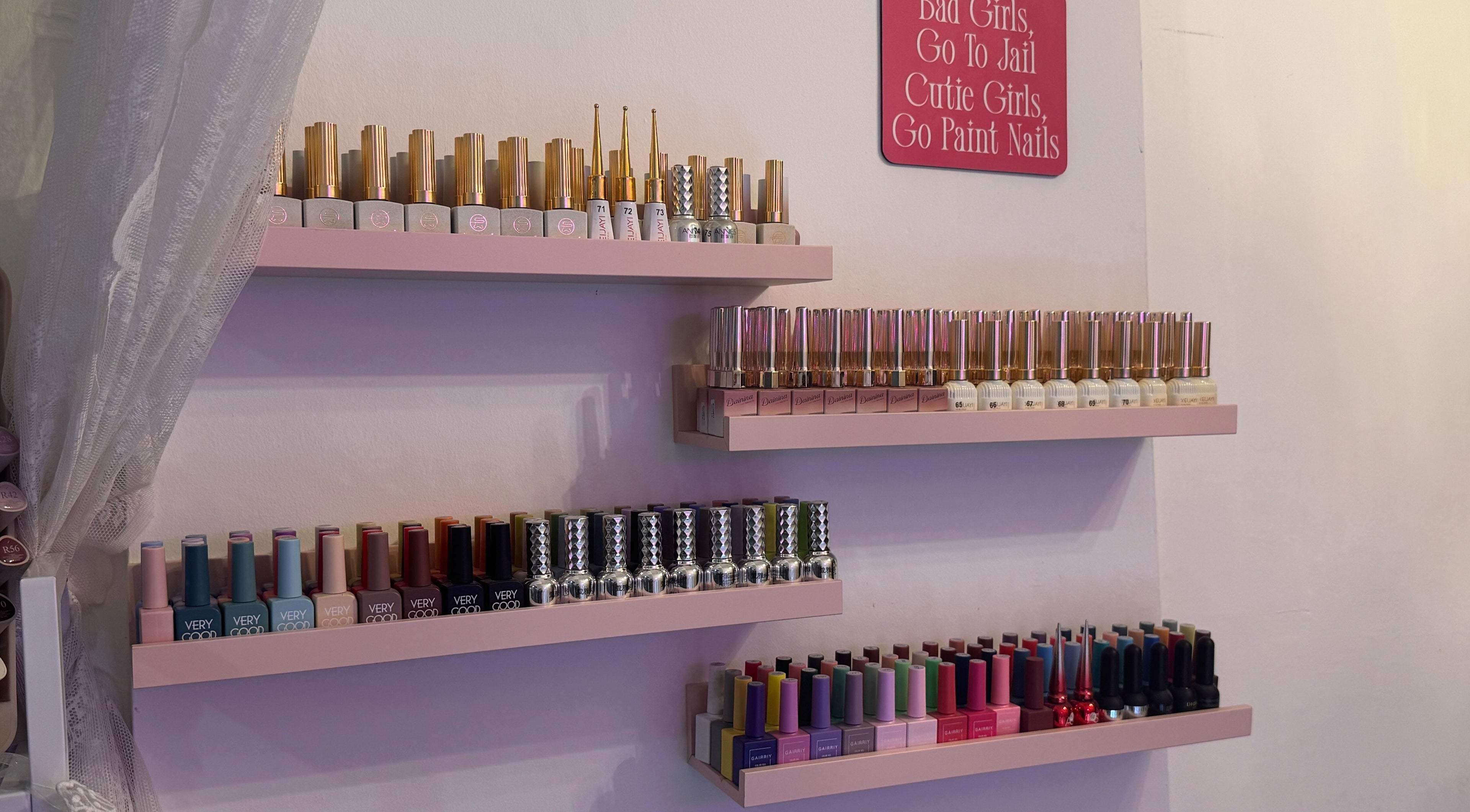 Nail polish collection at The Belle Studio, Singapore, SG showcasing vibrant colors on elegant shelves.
