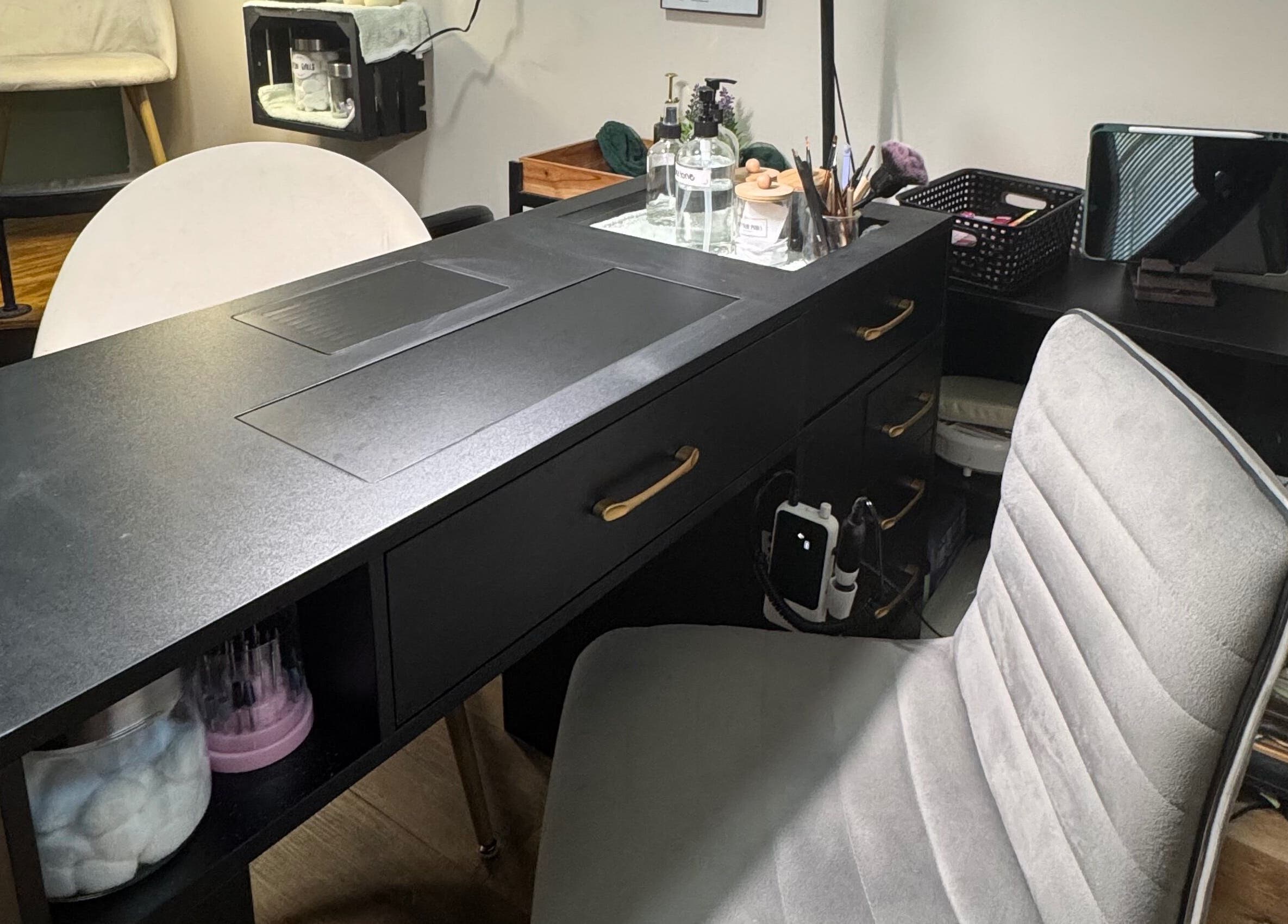 NailsByMaycee salon desk setup in Estill Springs, Tennessee, US, featuring a stylish chair and manicure tools.
