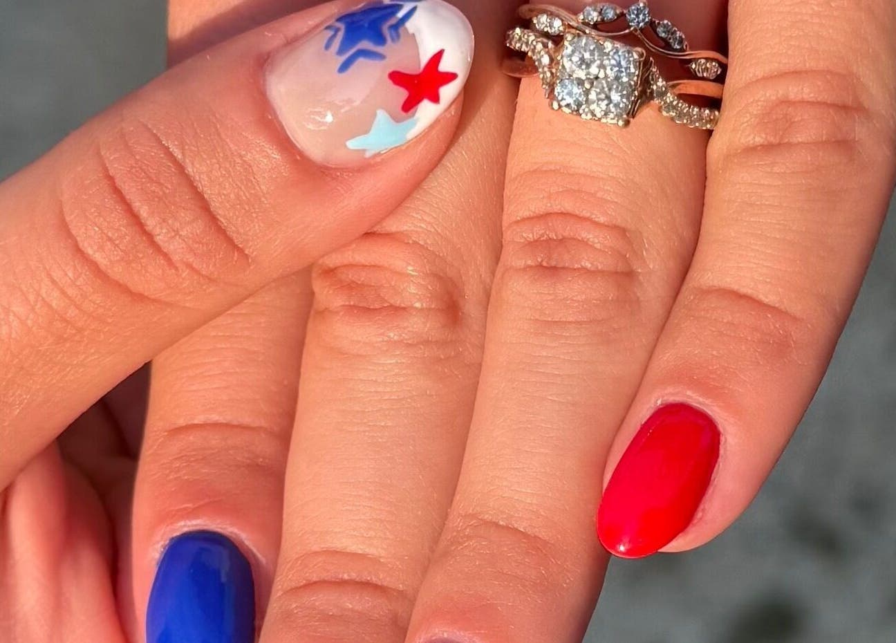 Close-up of patriotic nail art with blue, red stars at NailsByMaycee, Estill Springs, Tennessee, US.