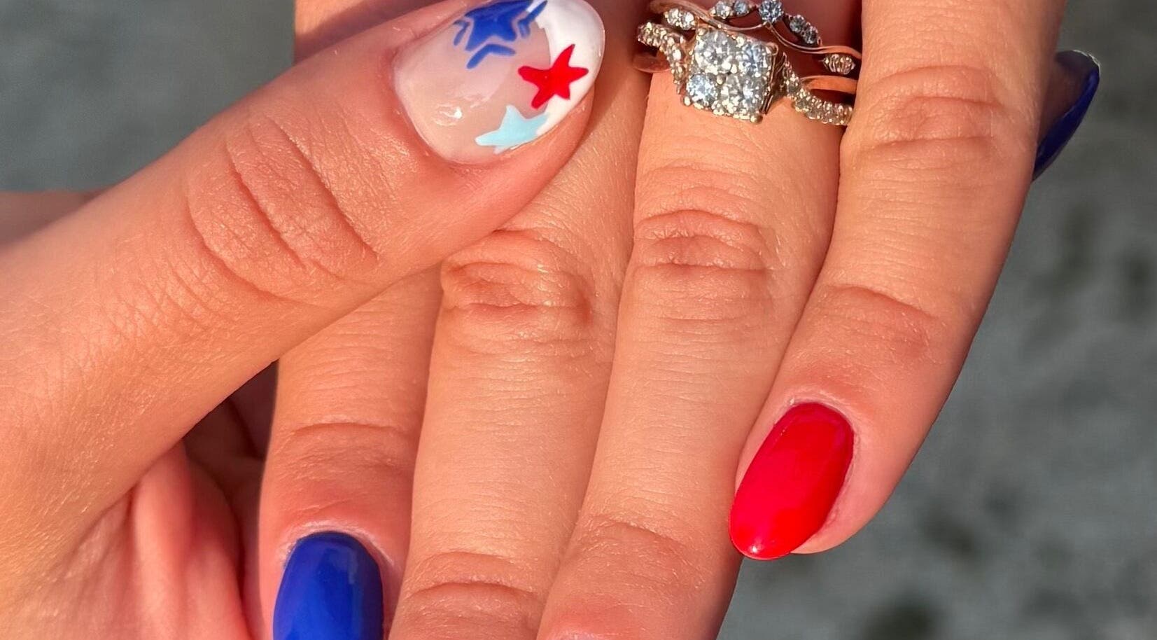 Close-up of patriotic nail art with blue, red stars at NailsByMaycee, Estill Springs, Tennessee, US.
