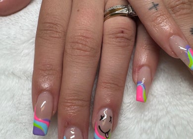 Colorful nail art featuring rainbow tips and smiley face design at NailsByMaycee, Estill Springs, Tennessee, US.