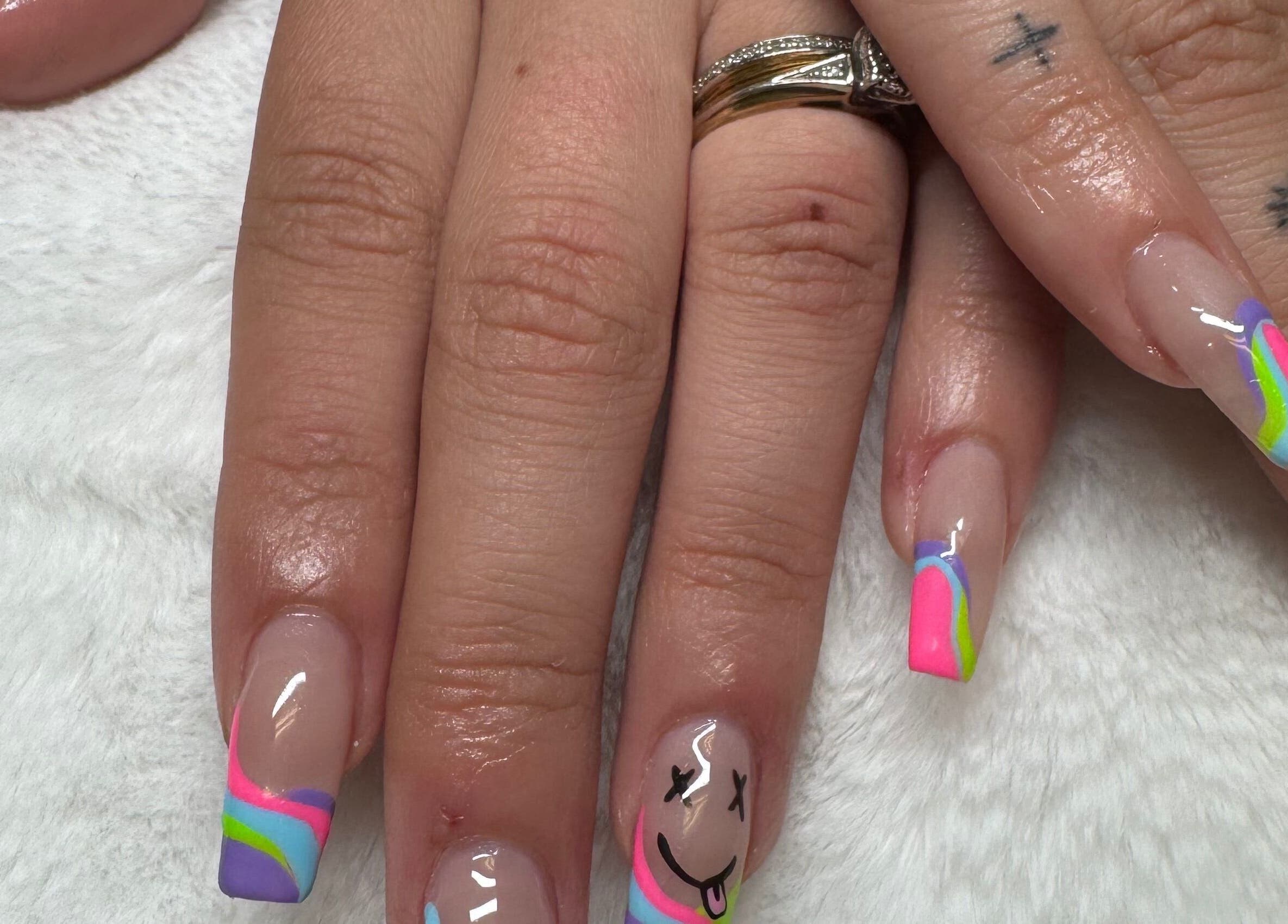 Colorful nail art featuring rainbow tips and smiley face design at NailsByMaycee, Estill Springs, Tennessee, US.