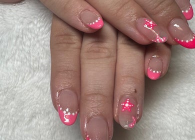 Elegant pink nail art with polka dots at NailsByMaycee in Estill Springs, Tennessee, US. Perfect for nail lovers.