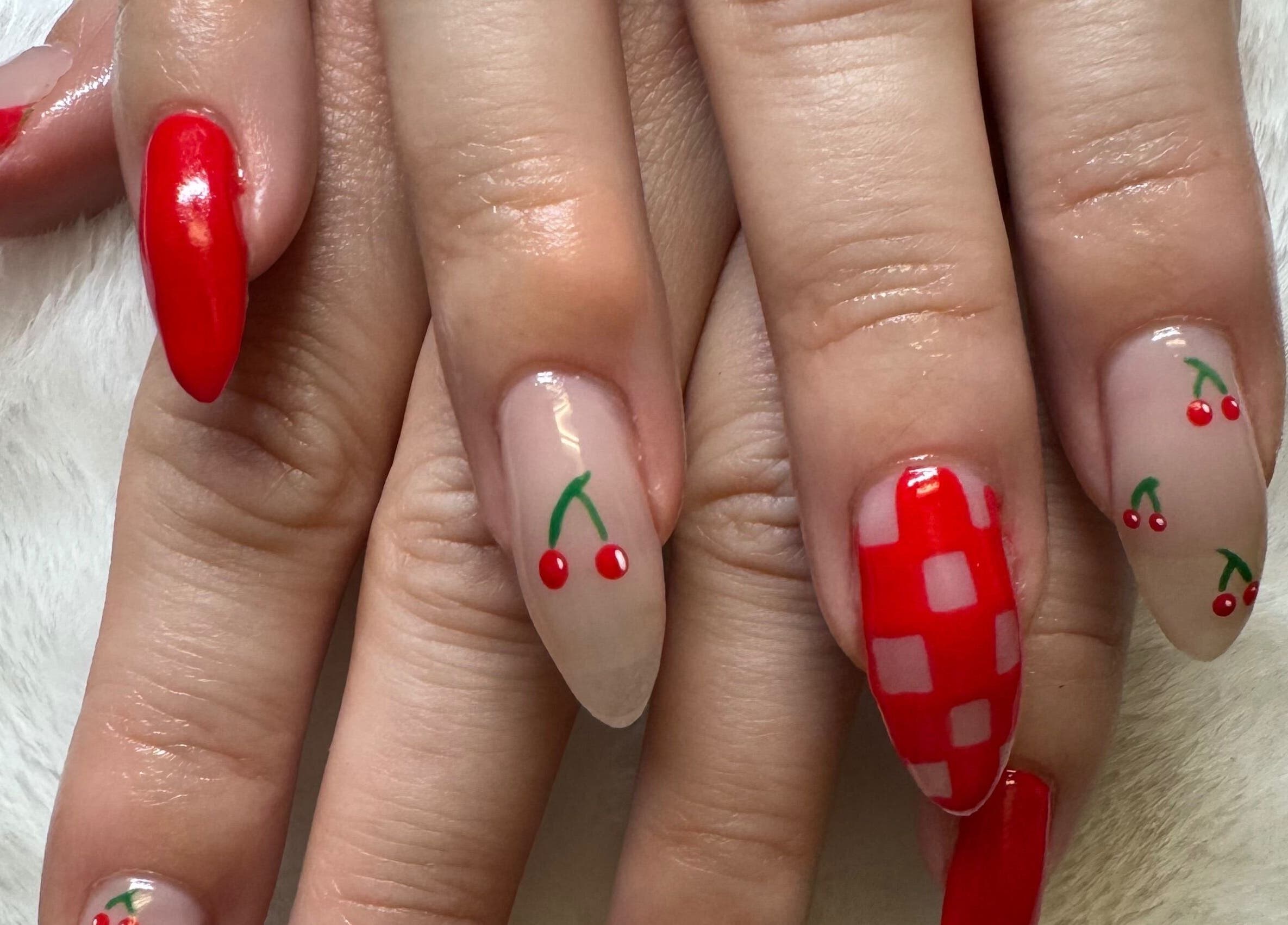 Stylish cherry-themed nail art by NailsByMaycee in Estill Springs, Tennessee, US.