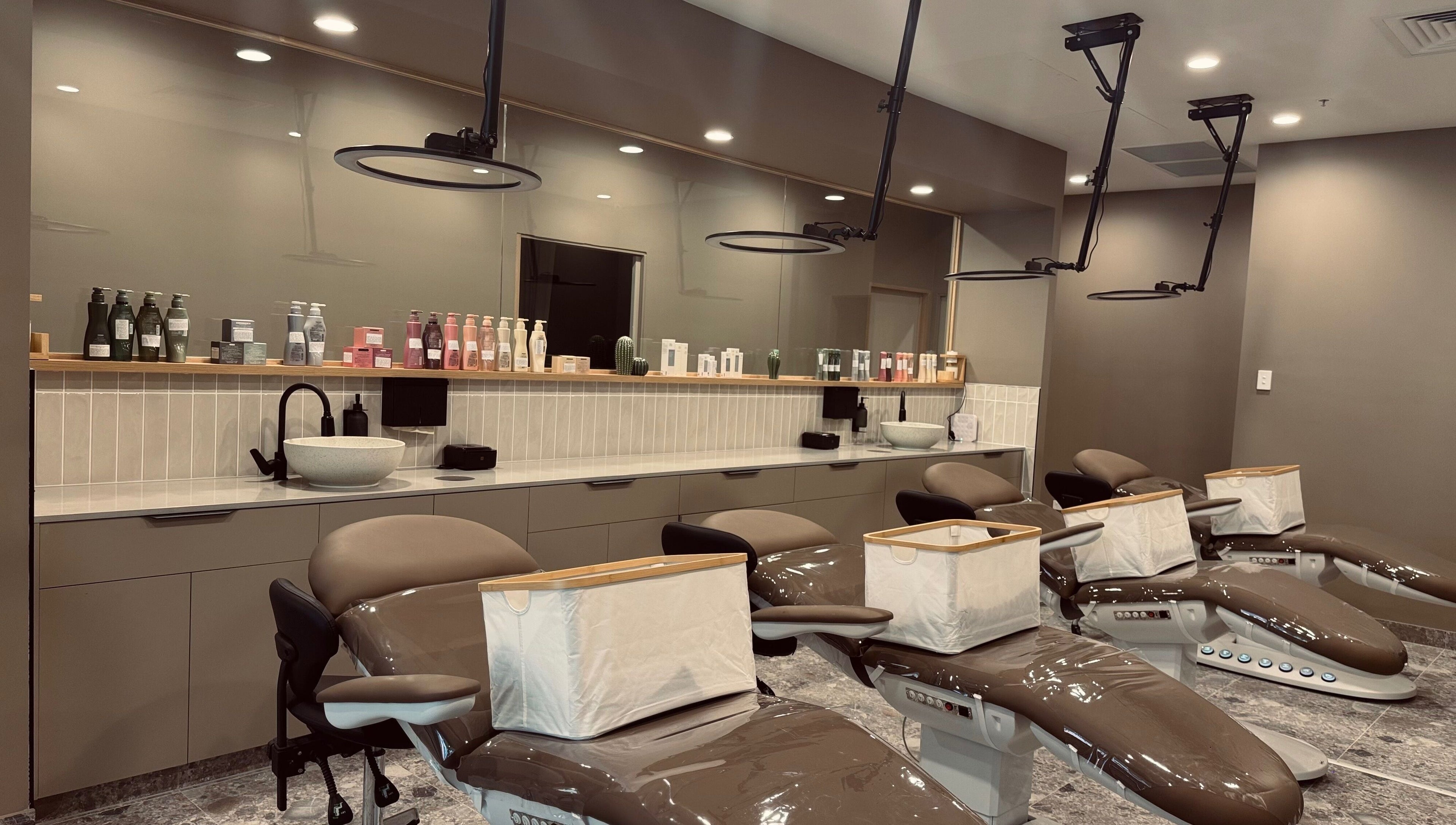 Chic interior of Bureau of Beauty in Yeerongpilly, Queensland, AU featuring elegant salon chairs and product display.