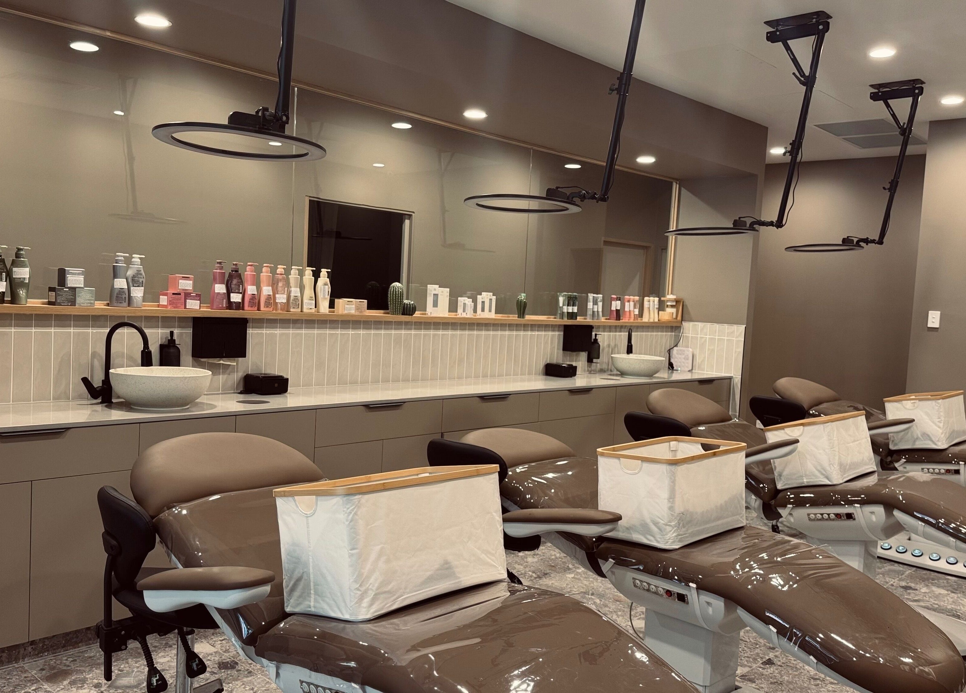 Chic interior of Bureau of Beauty in Yeerongpilly, Queensland, AU featuring elegant salon chairs and product display.