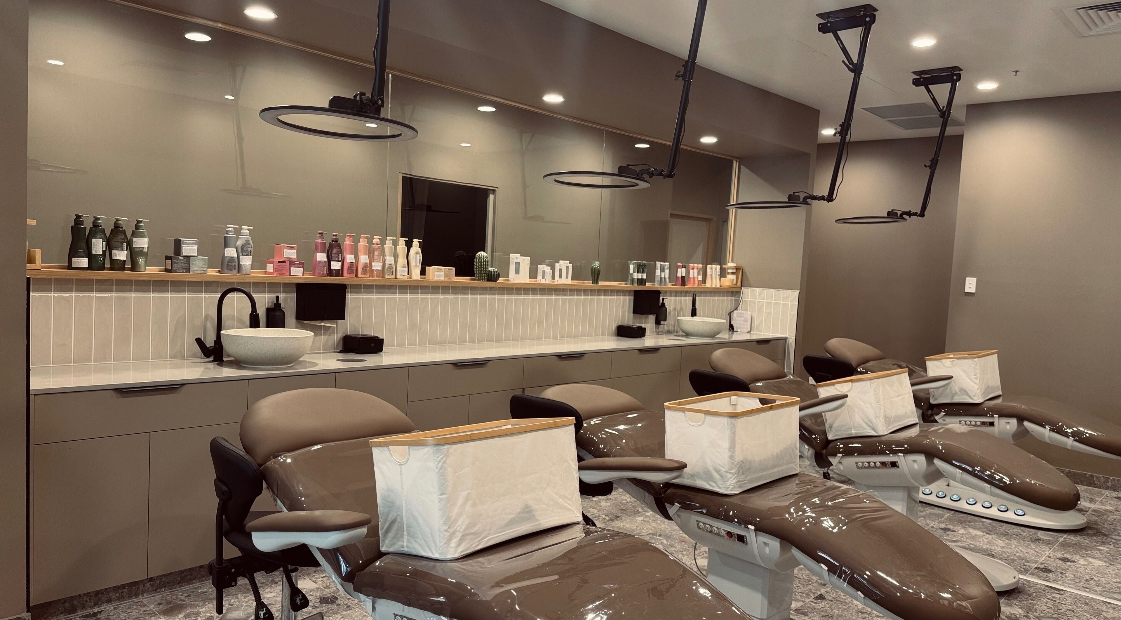 Chic interior of Bureau of Beauty in Yeerongpilly, Queensland, AU featuring elegant salon chairs and product display.