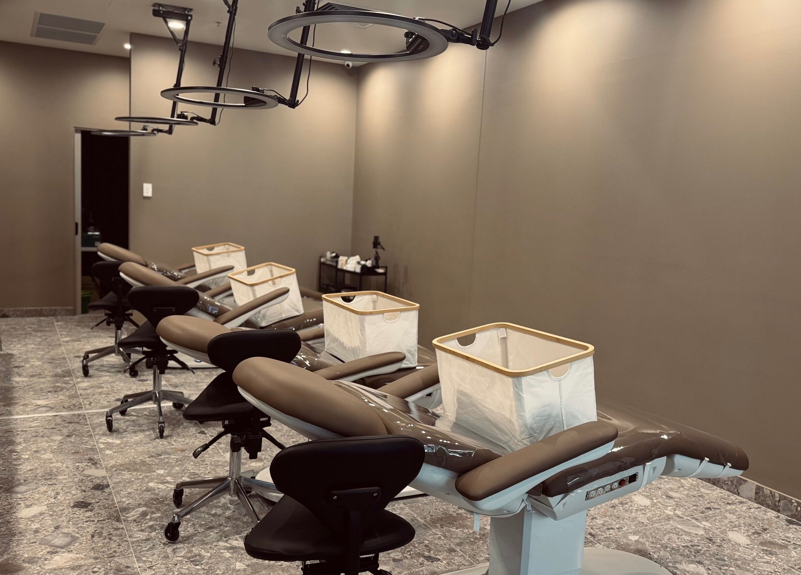 Modern beauty treatment room at Bureau of Beauty, Yeerongpilly, Queensland, AU with sleek chairs and equipment.