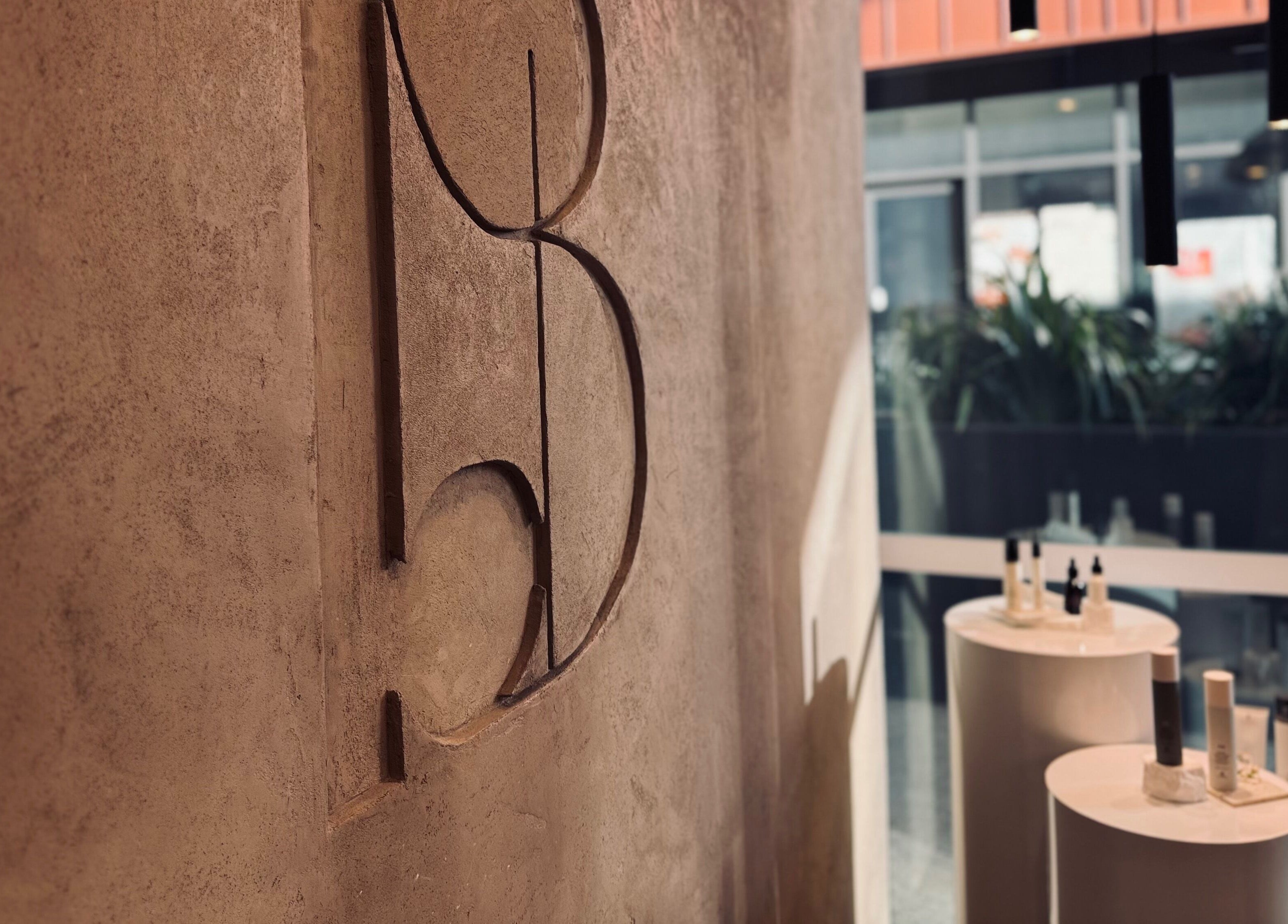 Chic interior of Bureau of Beauty in Yeerongpilly, Queensland, AU, with modern wall decor and beauty products display.