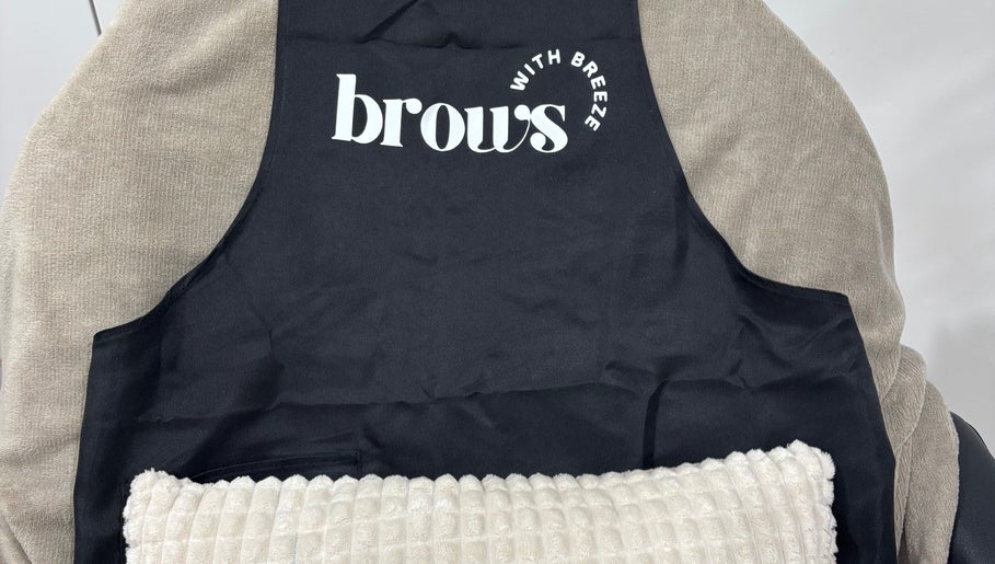 Cozy black apron on a soft chair at Brows With Breeze, Rufford Avenue, England, GB inviting relaxation.