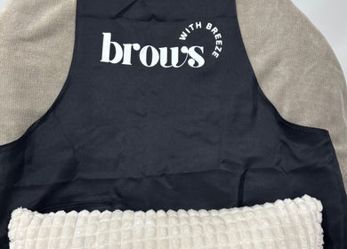 Cozy black apron on a soft chair at Brows With Breeze, Rufford Avenue, England, GB inviting relaxation.