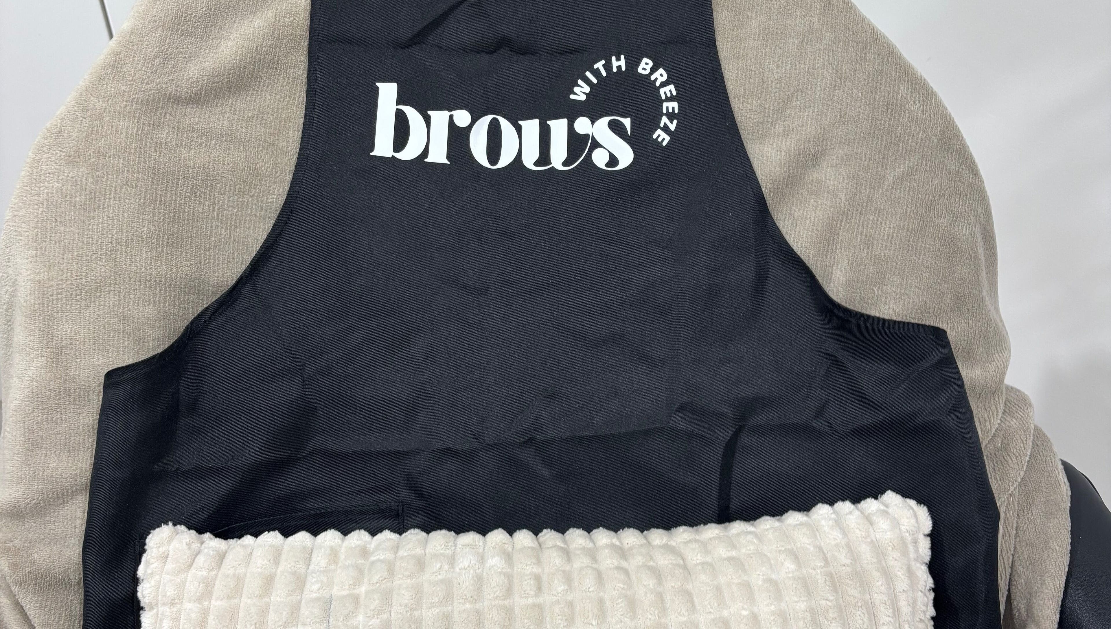 Comfortable treatment chair at Brows With Breeze, Rainworth, England, GB with branded cover.